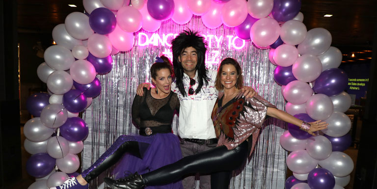 Kimberly Williams-Paisley, Jay Williams and Ashely Williams pose in front of a balloon arch.