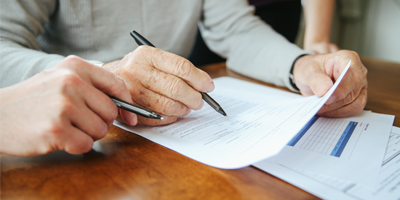 Two people reviewing paperwork, sitting side by side