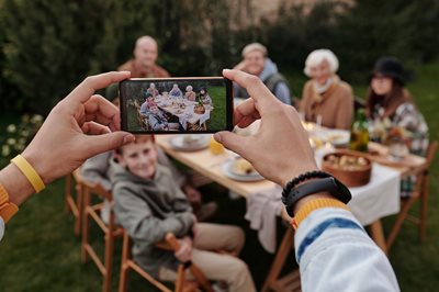 person taking picture at outdoor event