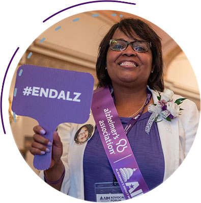 Picture of woman holding ENDALZ sign